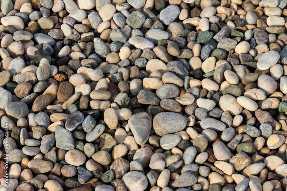 Smooth round pebbles texture background. Pebble sea beach close-up Smooth round pebbles texture background. Pebble sea beach close-up