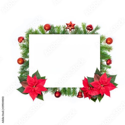 Red Christmas toys, spruce small sticks and poinsettia flowers on white isolated background. Christmas frame. Design elements. Holiday card, copy space.