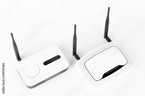 Two wifi routers, wireless devices with one and two antennas on white background.