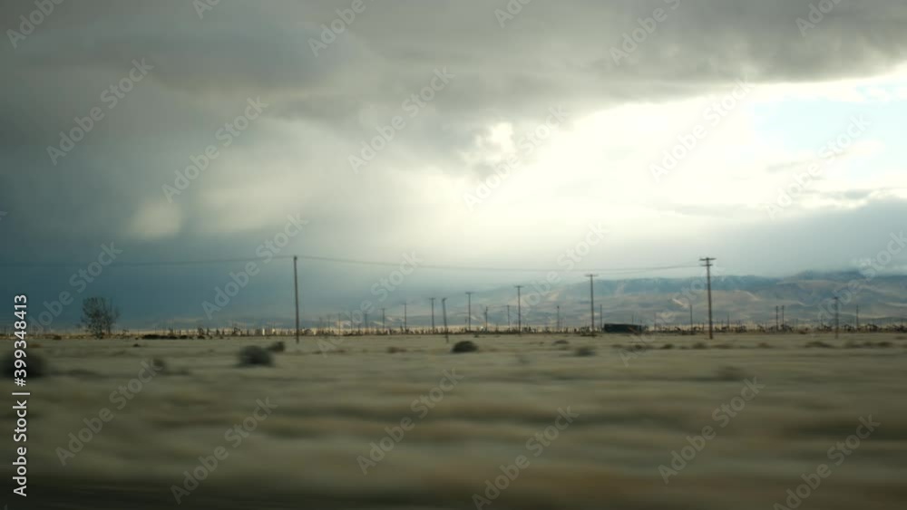 Driving auto, road trip in California, USA, view from car. Hitchhiking traveling in United States. Highway, mountains and cloudy dramatic sky before rain storm. American scenic byway. Passenger POV. Driving auto, road trip in California, USA, view from car. Hitchhiking traveling in United States. Highway, mountains and cloudy dramatic sky before rain storm. American scenic byway. Passenger POV.