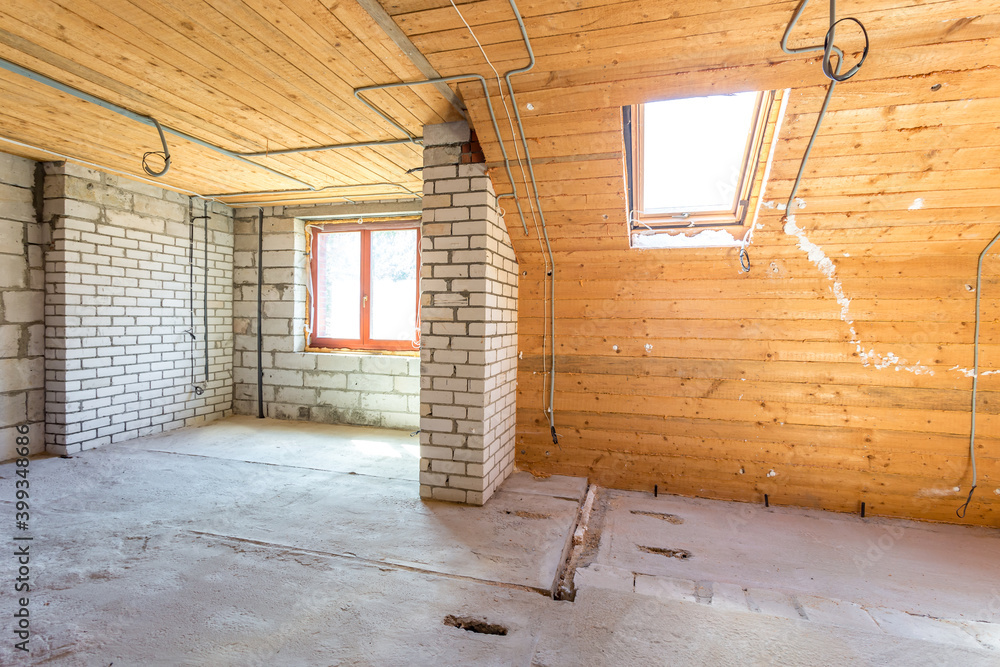 empty interior in house without repair on wooden mansard  floor and brick wall