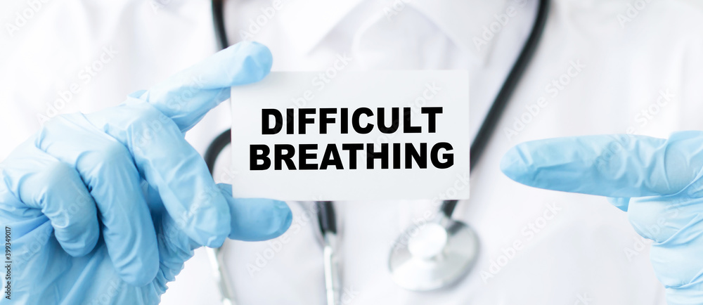 Doctor holding a paper card with text DIFFICULT BREATHING, medical concept Doctor holding a paper card with text DIFFICULT BREATHING, medical concept