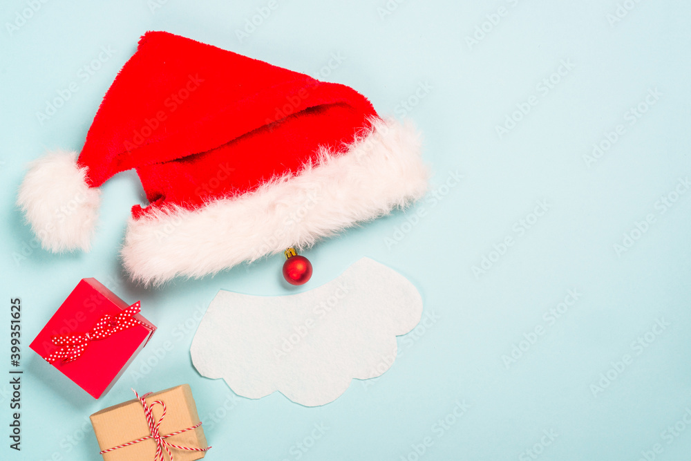 Creative christmas composition with Santa and presents. Flat lay image on blue background. Creative christmas composition with Santa and presents. Flat lay image on blue background.