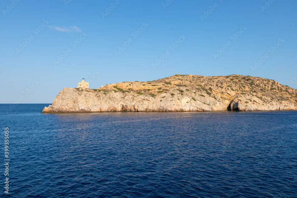 View of the lighthouse on the peninsula, Chora , Ios Island, Greece.