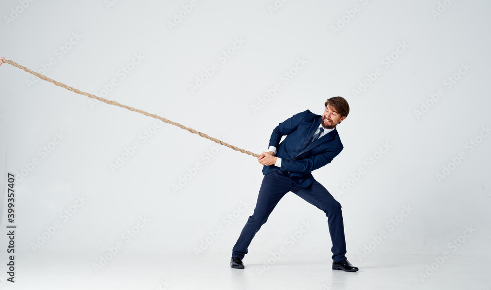 man with rope in hand on light background business finance advertising model