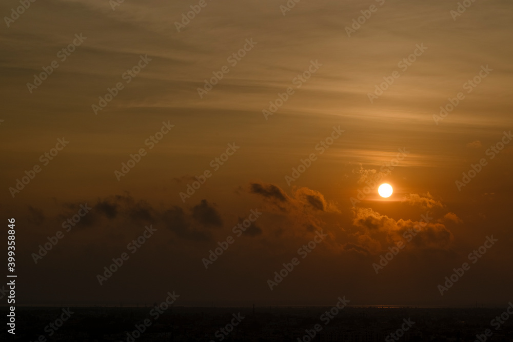 Beautiful sunset red sun over city.