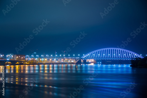 View of the Podilskyi Bridge with bright lights at night photo