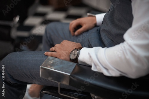 businessman with a watch sitting in a chair