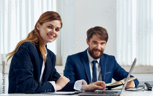 Wallpaper Mural Happy Business people in the office with a laptop are sitting at the table In a bright room Torontodigital.ca