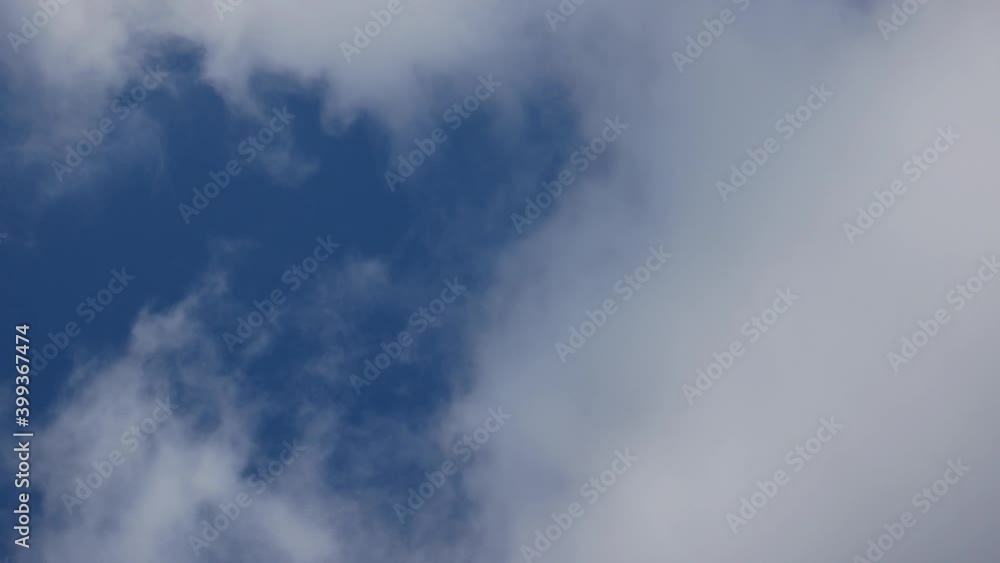 White clouds rush across blue sky White clouds rush across blue sky