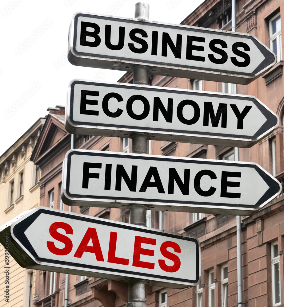 The road indicator on the arrows of which is written - business, economics, finance and SALES The road indicator on the arrows of which is written - business, economics, finance and SALES