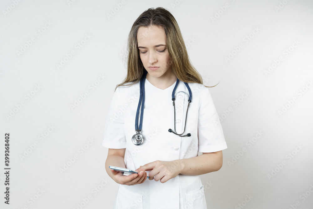 Medicine and health concept. Young woman doctor message in mobile phone. Medicine and health concept. Young woman doctor message in mobile phone.