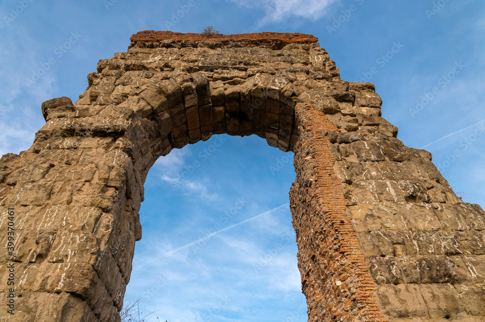 The Parco degli Acquedotti, in the Appio Claudio district, Tuscolano area, Cinecitt, Rome, is part of the Appia Antica Park. Detail of the arch of the bricks on a sunny day and blue sky The Parco degli Acquedotti, in the Appio Claudio district, Tuscolano area, Cinecitt, Rome, is part of the Appia Antica Park. Detail of the arch of the bricks on a sunny day and blue sky