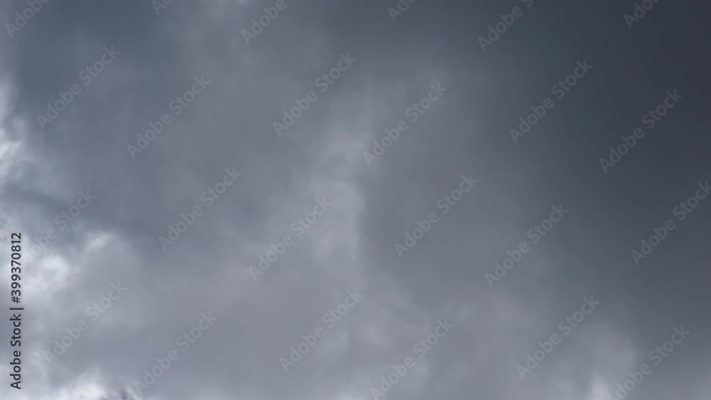 Real time video of clear sunny blue sky covered with dark gray rainy huge cloud. Overcast rainy weather concept. Natural background. Real time video of clear sunny blue sky covered with dark gray rainy huge cloud. Overcast rainy weather concept. Natural background.