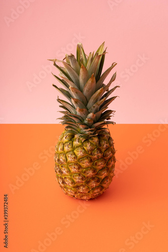 Pineapple on pink and orange background. Abstract colors art background. Top view. Flat lay. 