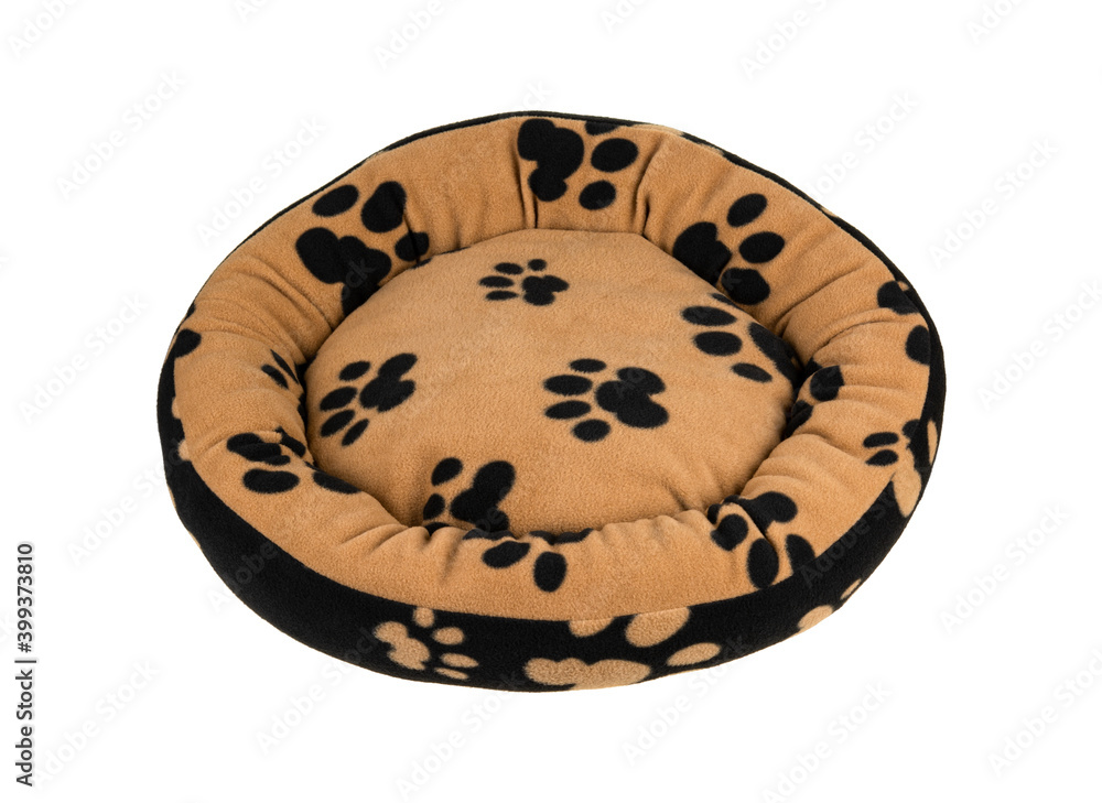 Pet's paw print on a soft and fluffy dog's bed isolated on white background