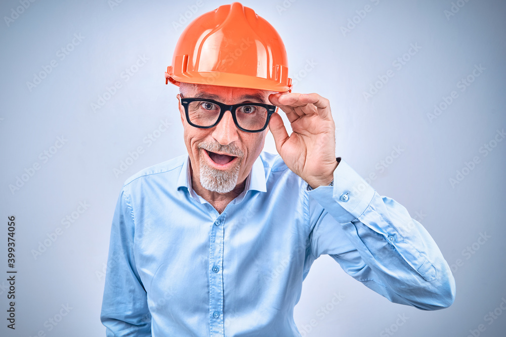 Happy mature bearded employee in safety helmet Happy mature bearded employee in safety helmet