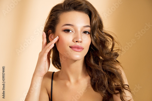 Beautiful woman with perfect makeup on beige background. Beauty and skin care concept