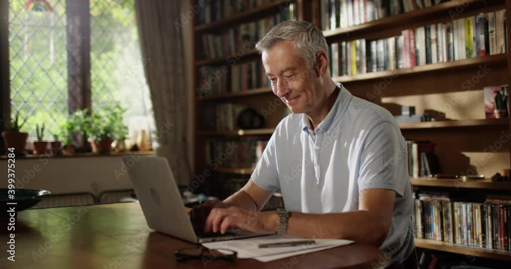 4k, Happy and cheerful senior businessman using laptop at home 4k, Happy and cheerful senior businessman using laptop at home