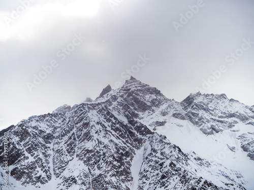 Top view of winter mountains covered with clouds © alexkazachok