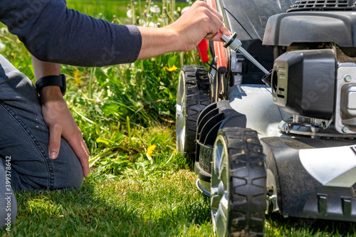 change and check the oil in the motor lawn mower photo