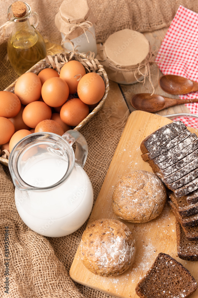 Homemade chicken eggs and freshly baked bread on a wooden table. Homemade chicken eggs and freshly baked bread on a wooden table.