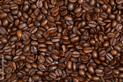 Fullframe shot of roasted coffee beans frome close up. fullframe with background. Brown aromatic seeds on background.