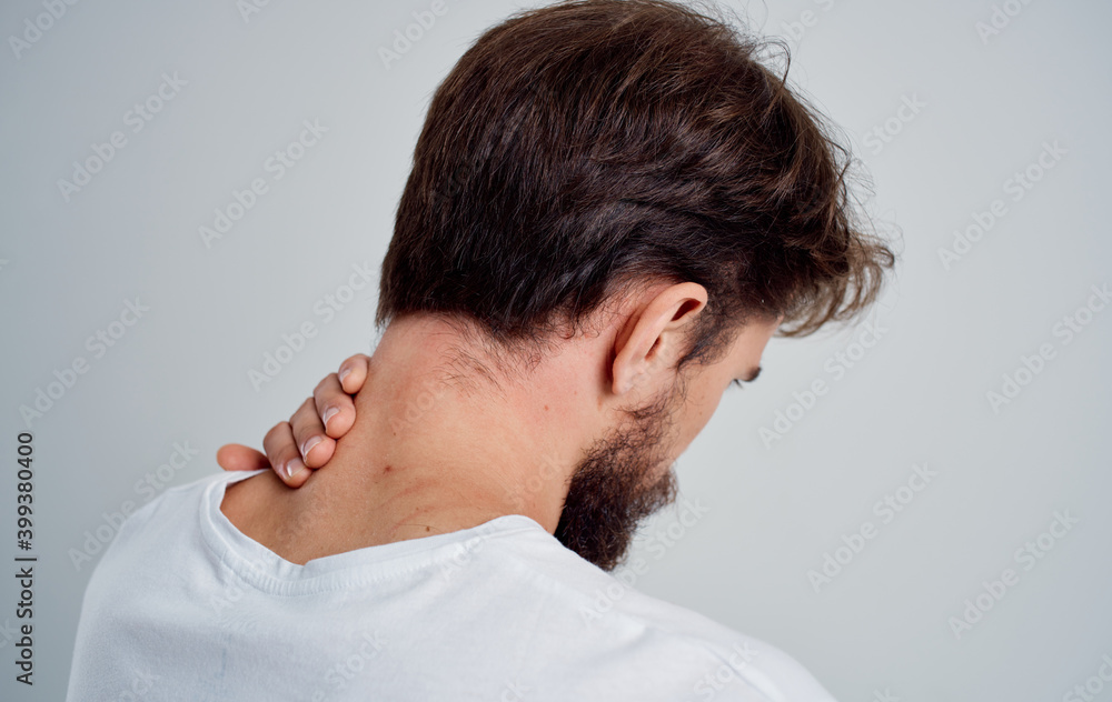 Fototapeta premium man touches his neck with his hand injury pain osteochondrosis problems with the spine