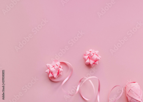 Gift wrapping Top view photo in minimal style Pink paper bows and ribbons on light pink background Photo with copy space