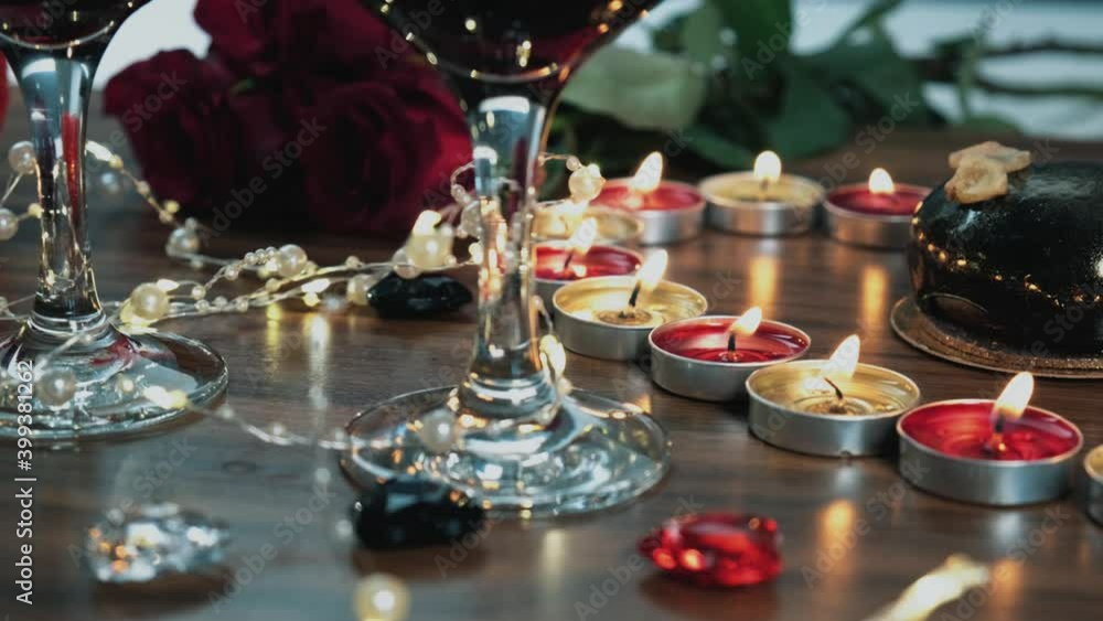 Mousse chocolate cake, glasse next to candles and a bouquet of red roses. Romantic setting on Valentine's day. Mousse chocolate cake, glasse next to candles and a bouquet of red roses. Romantic setting on Valentine's day.