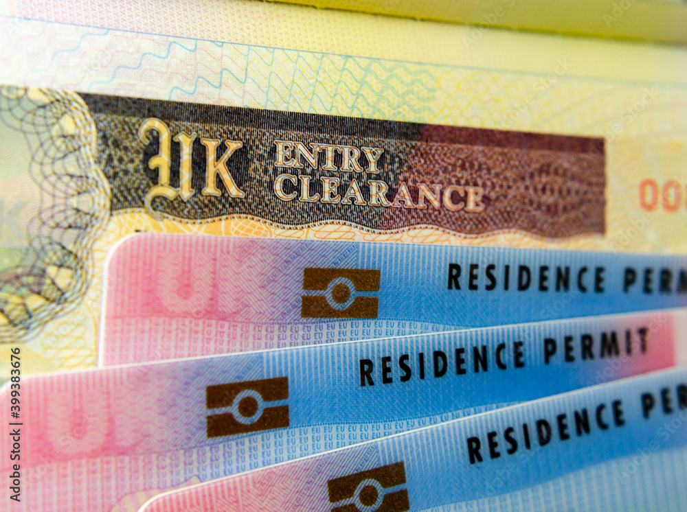 UK BRP (Biometrical Residence Permit) cards for Tier 2 work visa placed on  top of United Kingdom Entry Clearance vignette sticker in the passport.  Close up photo. Stock Photo | Adobe Stock