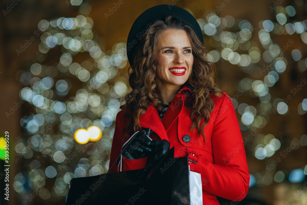 smiling solo traveller woman outside in city street at night smiling solo traveller woman outside in city street at night