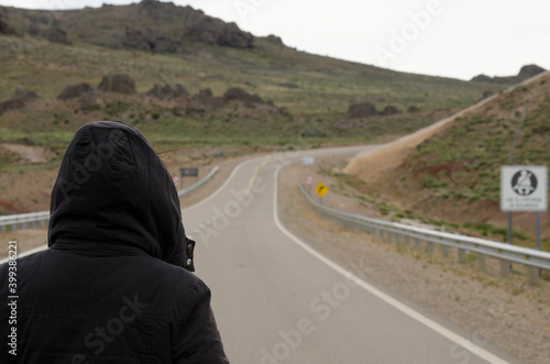young woman on empty mountain road, winter day