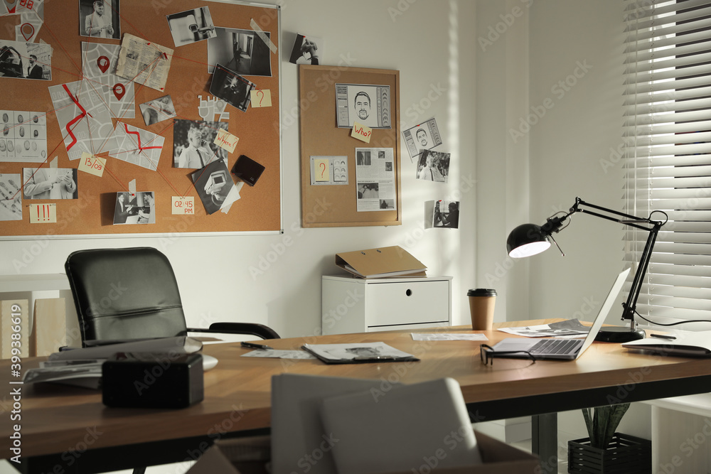 Detective office interior with big wooden desk and evidence board Detective office interior with big wooden desk and evidence board