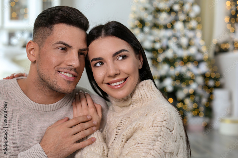 Fototapeta premium Happy couple in festively decorated room. Christmas celebration