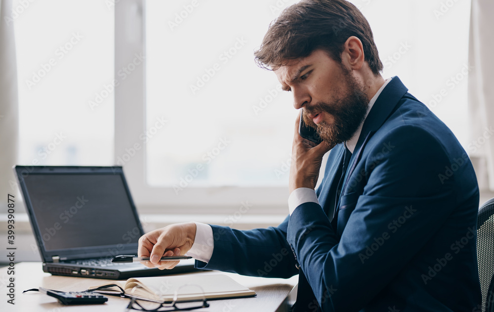 businessman in a suit mobile phone at the table in the office emotions model communication businessman in a suit mobile phone at the table in the office emotions model communication