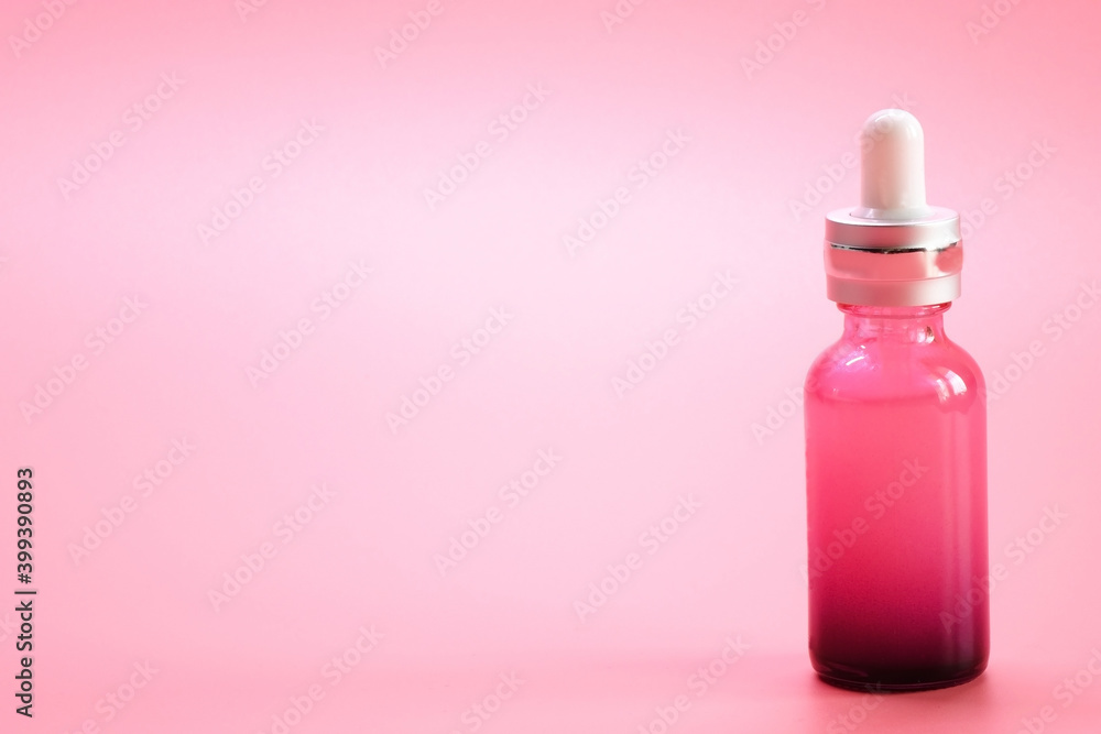 Serum bottle. Luxury pink glass serum bottle on pink color background. Serum bottle. Luxury pink glass serum bottle on pink color background.