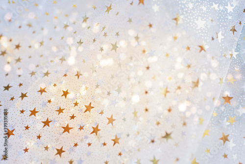 gold glitter and glittering stars on white festive background. Winter holidays background. Christmas and Happy New Year greeting card. Wedding. Birthday. selective focus