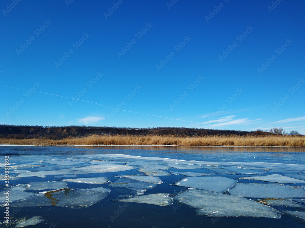 Ice floes float on the river. Thaw at the end of winter