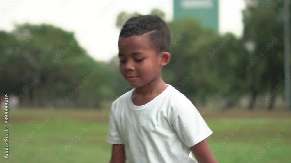 Portrait of Afican American boy with football, kid playingnd in a park. Portrait of Afican American boy with football, kid playingnd in a park.