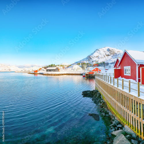 Traditional Norwegian red wooden houses on the shore of Sundstraumen strait