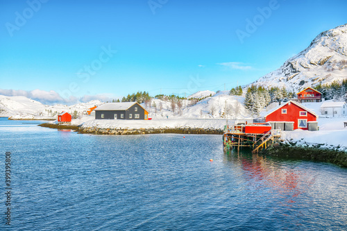 Traditional Norwegian red wooden houses on the shore of  Sundstraumen strait photo