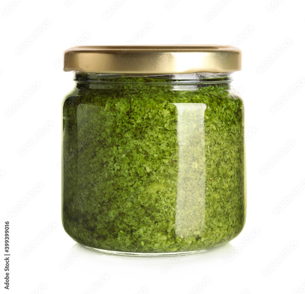 Jar of tasty arugula pesto on white background Jar of tasty arugula pesto on white background