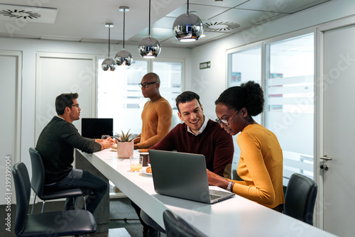 Business partners chatting on coffee break in office