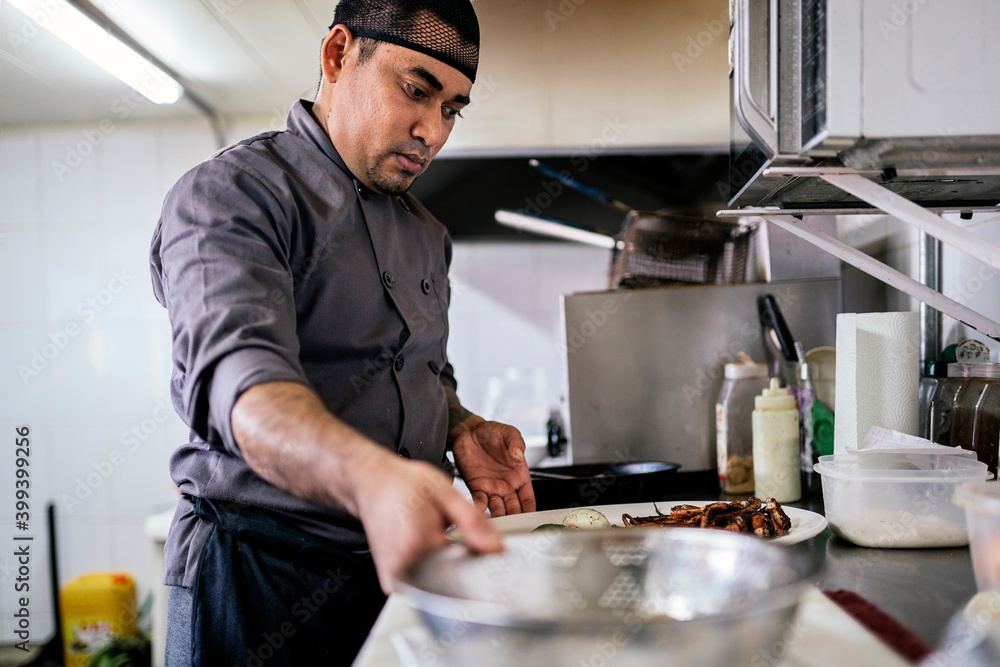 Chef preparing food in kitchen. Chef preparing food in kitchen.