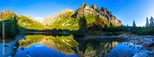 Fototapeta Naklejka Na Ścianę i Meble -  Picturesque panorama of mountain glacier lake Poprad (Slovak: Popradske pleso) in High Tatras (Slovak: Vysoke Tatry), Slovakia. Autumn in the mountains. Evening view
