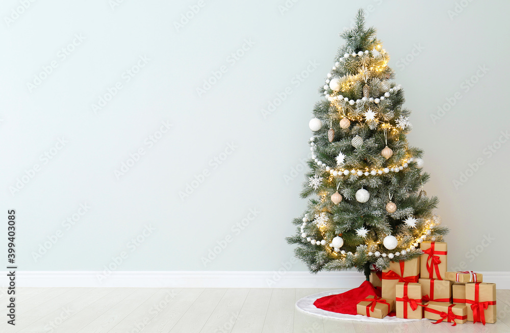 Decorated Christmas tree with red skirt and gifts indoors, space for text Decorated Christmas tree with red skirt and gifts indoors, space for text
