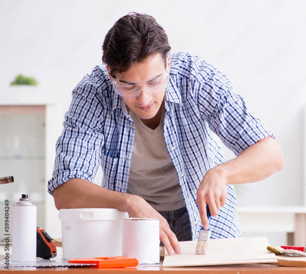Young man in woodworking hobby concept