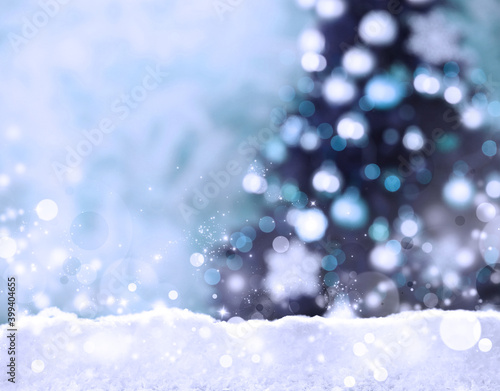 Snow and blurred view of beautiful decorated Christmas tree. Bokeh effect