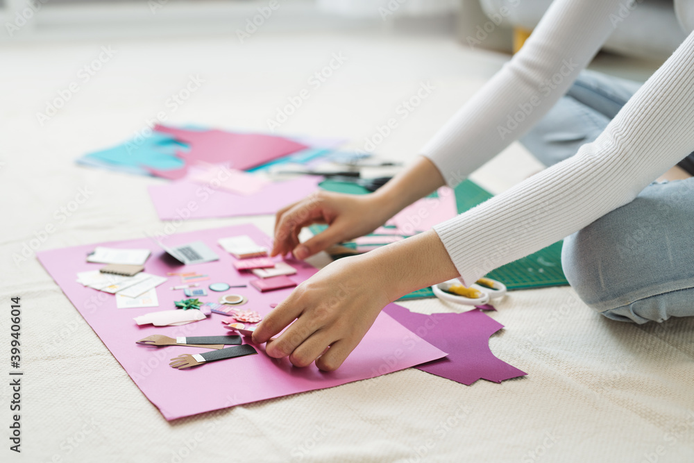 Female hands making craft paper works Female hands making craft paper works